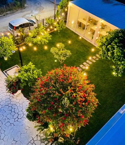 an aerial view of a yard with flowers and lights at Villa SOLIS in Vlorë