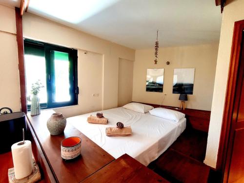 a bedroom with a bed with two towels on it at Psalidi beach house in Psalidi