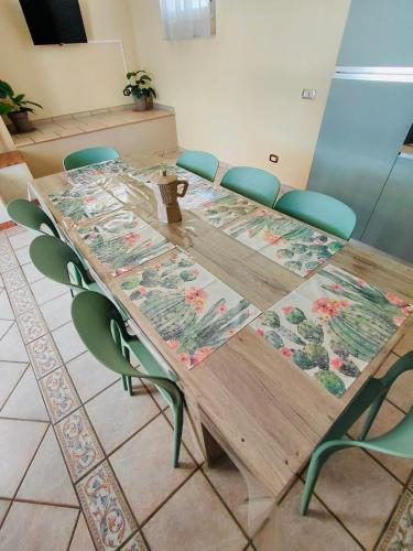 a long wooden table with chairs around it at PIAZZA COPERTA Casa Vacanza in Aradeo