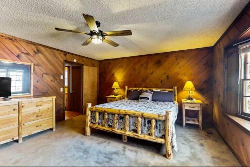 a bedroom with a bed and a ceiling fan at Coos Moose in Ellijay
