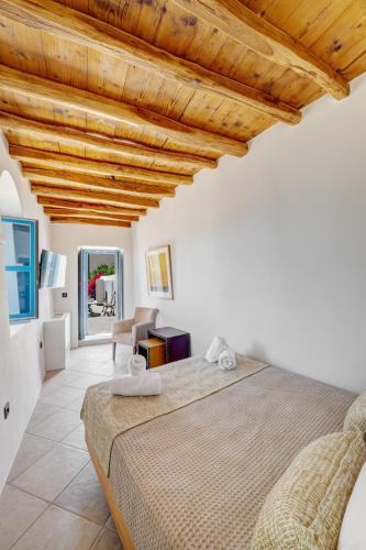 a bedroom with a large bed in a room at Totem in Ano Syros