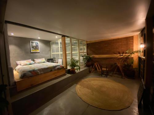 a bedroom with a large bed and a rug at Embibi Mindfulness Cabins in Ngong