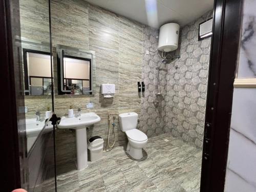 a bathroom with a toilet and a sink at Holiday Homes in Ras al Khaimah