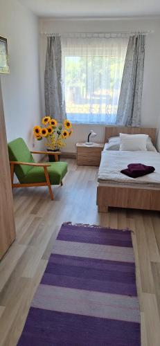 a bedroom with a bed and a large window at Elizabeth in Komárom