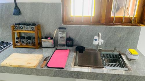 a kitchen counter with a sink and a cutting board at Mayon villa in Midigama East