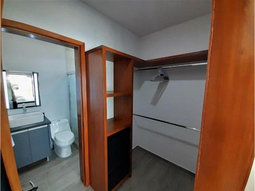 a small bathroom with a toilet and a sink at Casa en Lago Rapel, Quebrada Honda in Lago Rapel
