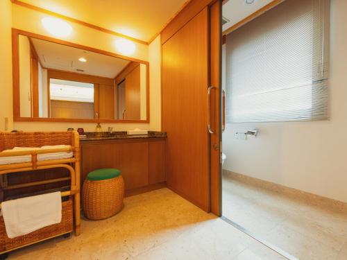 a bathroom with a sink and a toilet and a mirror at Racine Shinmaebashi in Maebashi