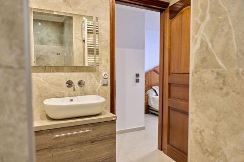 a bathroom with a sink and a mirror at 180 View Private 2 Bedroom Seaview Home in Samos
