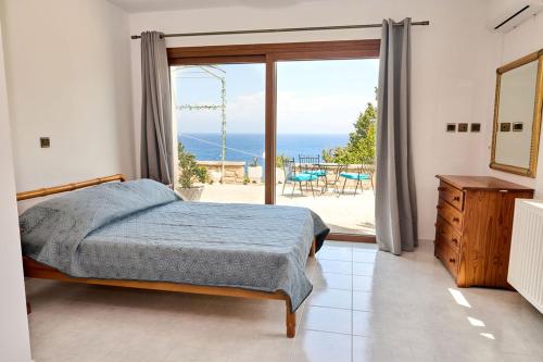 a bedroom with a bed and a view of the ocean at 180 View Private 2 Bedroom Seaview Home in Samos