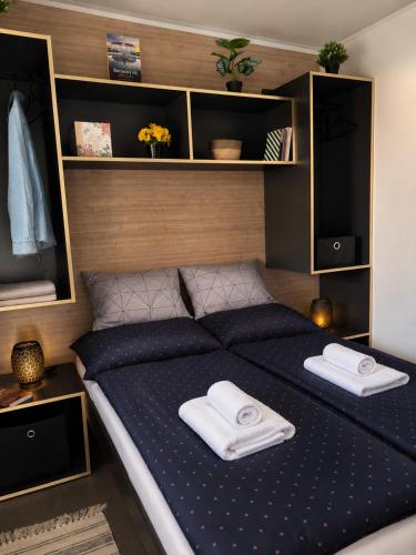 a bedroom with a bed with towels on it at SevenSeasCove in Sukošan