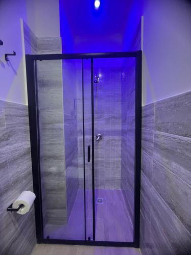 a shower with a glass door in a bathroom at Il Faro Suites in Taranto