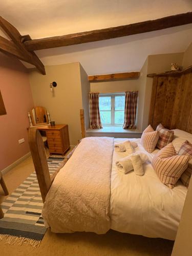 a bedroom with a large bed in a room at Beck cottage in Rosedale Abbey