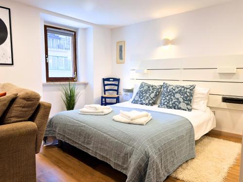 a bedroom with a bed with two towels on it at Luxury holiday home near Lake Bled & the Alps in Kropa