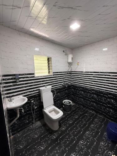 a bathroom with a toilet and a sink at Om residency in Diveagar