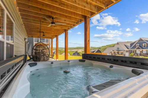 a hot tub on the back of a house at Green Wood Getaway - for 18 in Hollister