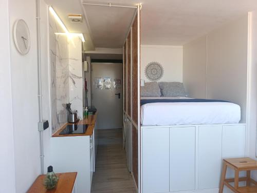 a bedroom with a bed in a small room at "El Rincón de Sevilla 3" A 9 min en metro del centro de Sevilla in San Juan de Aznalfarache