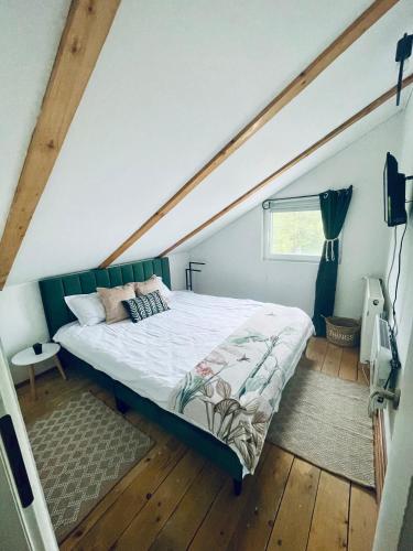 a bedroom with a large bed in a attic at LaOgrada in Avrig