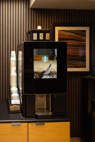 a tv sitting on top of a dresser at Sheraton Tucson Hotel & Suites in Tucson