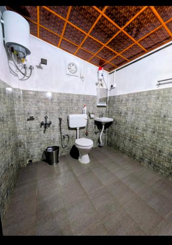 a bathroom with a toilet and a sink at Peter and Paul Homestay in Shillong