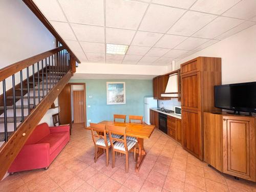 a kitchen and dining room with a table and a couch at Agriturismo Nani in Altavilla Monferrato