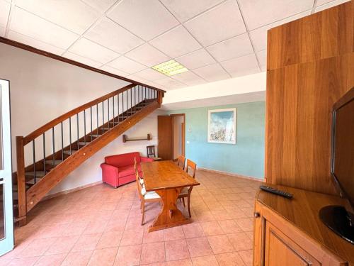 a living room with a table and a staircase at Agriturismo Nani in Altavilla Monferrato