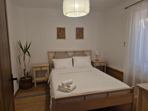 a bedroom with a bed with two towels on it at Casa LADIS in Iernut