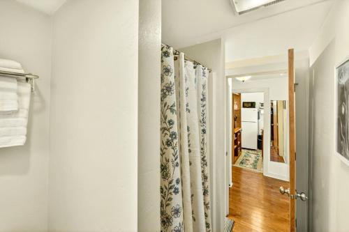 a hallway with white walls and a shower curtain at Whimsy On B- 1 block to downtown Ashland in Ashland