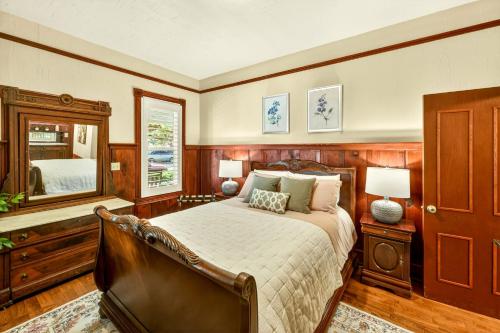 a bedroom with a bed and a large mirror at Whimsy On B- 1 block to downtown Ashland in Ashland