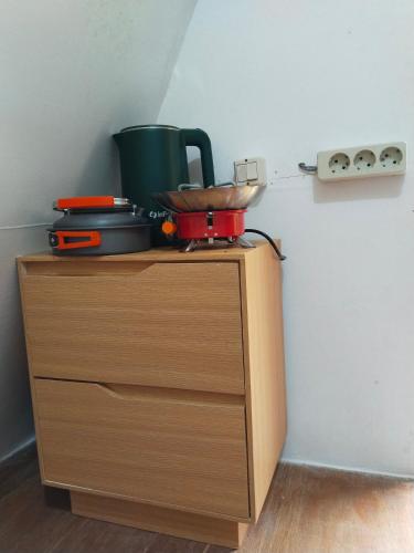 a cabinet with a pot on top of it at Cihulu Budget Glamping in Tengahgirang