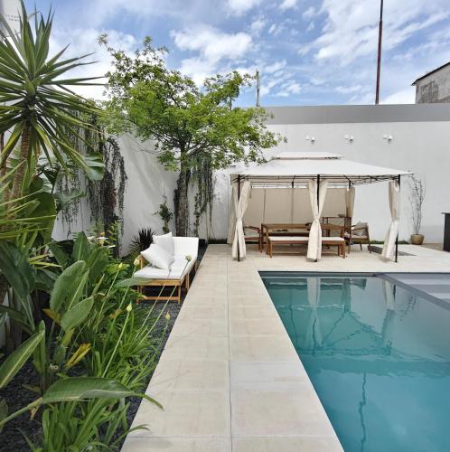 a patio with a swimming pool next to a house at Moderninfluence - Aparthotel in Porto