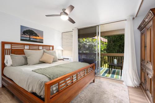 a bedroom with a bed and a large window at Kona Mansions#226 in Kailua-Kona