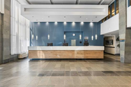 a lobby with a reception desk in a building at Sandman Hotel & Suites Calgary West in Calgary