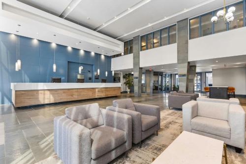 an office lobby with chairs and a reception desk at Sandman Hotel & Suites Calgary West in Calgary
