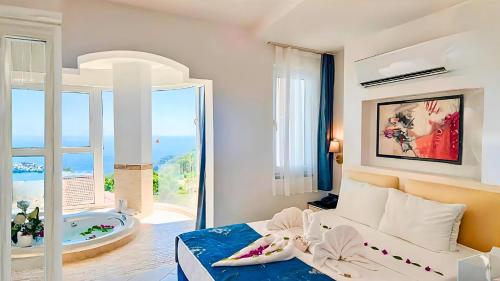 a bedroom with a bed with a view of a tub at Azure Palm Resort in Oludeniz