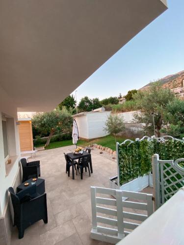 a patio with a table and chairs in a yard at il tramonto in Capaci
