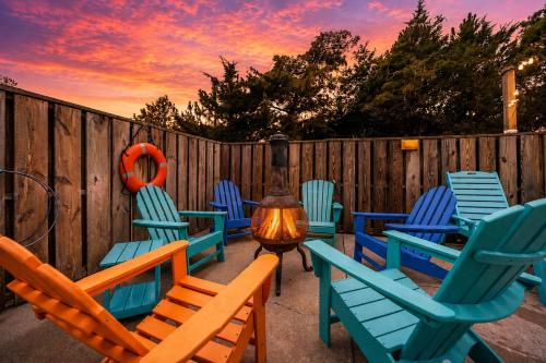 a group of lawn chairs and a heater with a sunset at OPM Coastal Retreat in Salvo