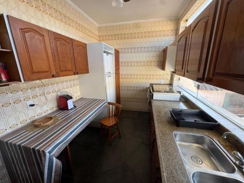 a small kitchen with a counter and a sink at Casa Villa Coloniale in Espirito Santo Do Pinhal