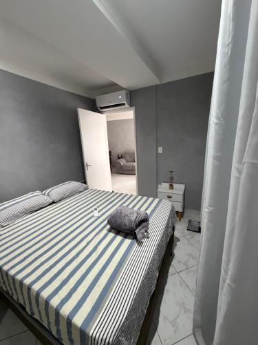 a bedroom with a bed with a pillow on it at Premium Feira ap 01 - Ar - Feiraguay - 24H check-in in Feira de Santana