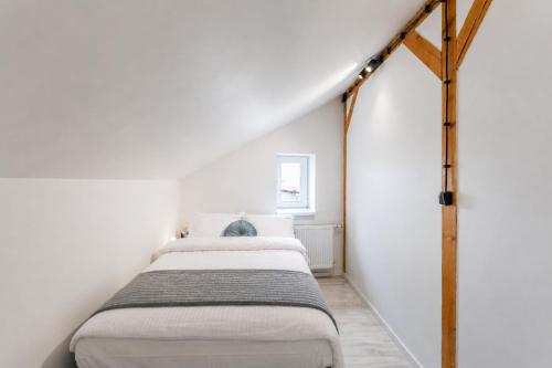 a bedroom with two beds in a white room at Apartment Quiet Street 11/7E in Oświęcim