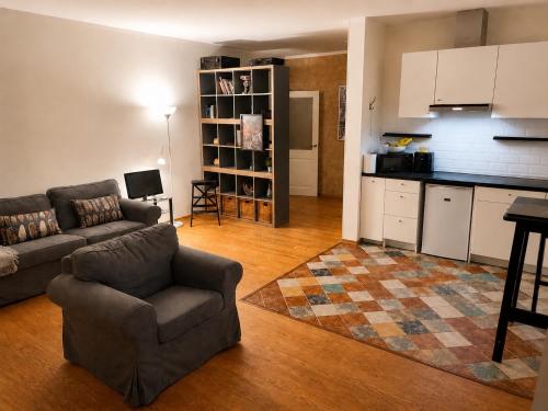 a living room with a couch and a kitchen at Babite Quiet Apartment in Babīte