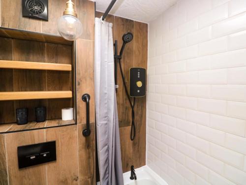 a bathroom with a shower with a shower curtain at May Cottage in Pentewan