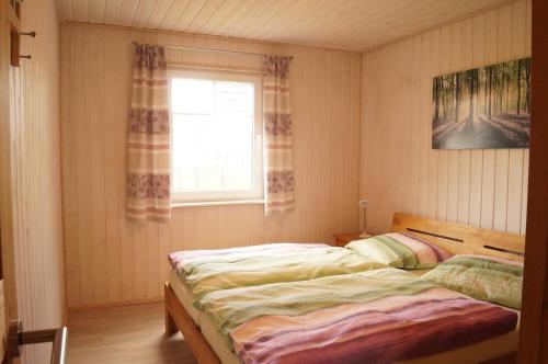 a bedroom with two twin beds and a window at Ferienhaus Heideblick in Zerpenschleuse