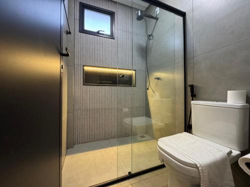 a bathroom with a shower and a toilet at Haven Residence in Uberlândia
