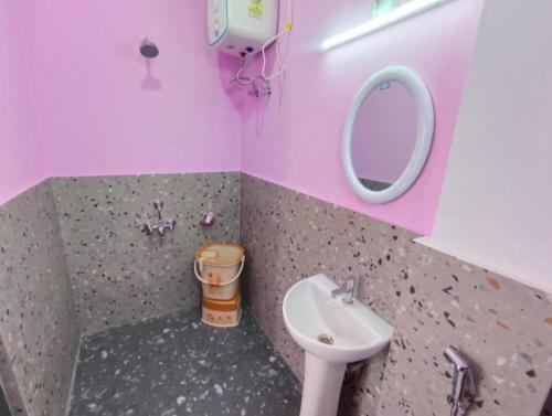 a bathroom with a sink and a mirror at La Murphy Homestay in Cherrapunji