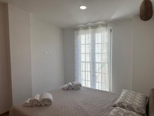 a bedroom with a bed with towels on it at Chiara 5 in Cairo Montenotte