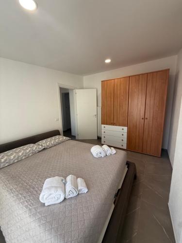 a bedroom with a bed with towels on it at Chiara 5 in Cairo Montenotte
