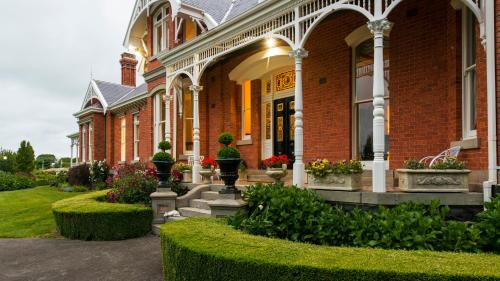 a large building with a garden in front of it at Arcoona Manor in Deloraine
