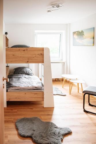 a bedroom with a wooden bunk bed in a room at Ferienwohnungen Kreuzer in Regen