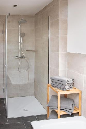 a bathroom with a shower and a table with towels at Ferienwohnungen Kreuzer in Regen