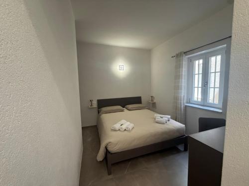 a bedroom with a bed with towels on it at Chiara 3 in Cairo Montenotte